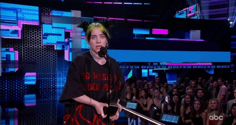 Billie Eilish wearing a T-shirt that says “No Music on a Dead Planet”
