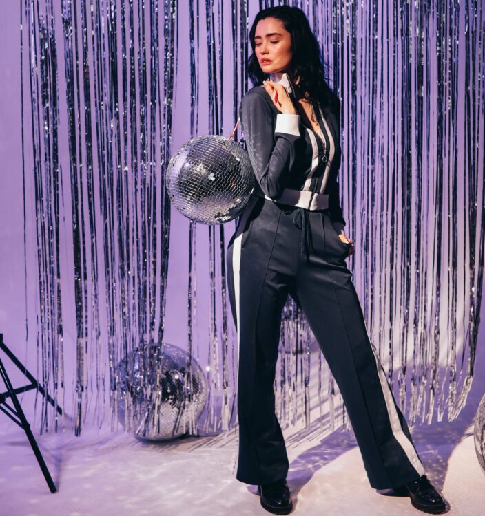 Woman in Tracksuit Posing with a Disco ball
