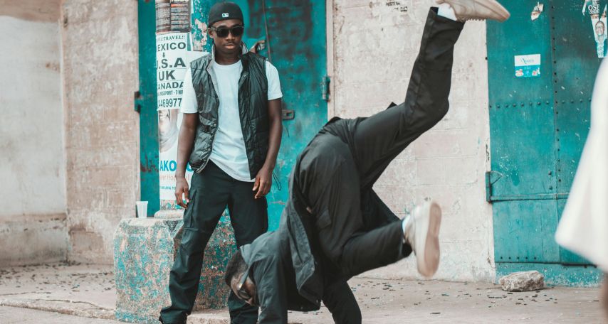 Men Breakdancing on a City Street