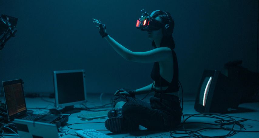 A Woman in a Tank Top Using a VR Headset
