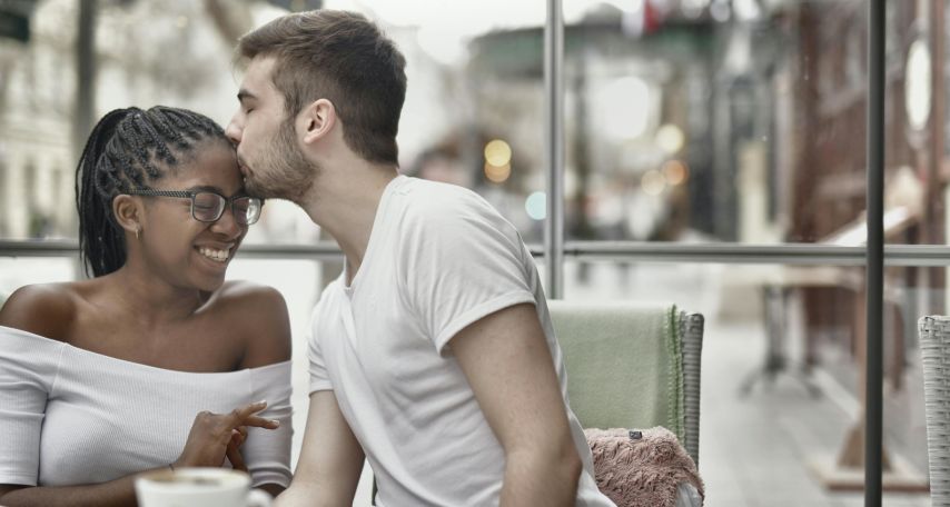 A Man Kissing a Woman's Forehead
